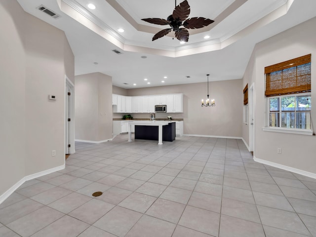 unfurnished living room featuring light tile patterned floors, ceiling fan with notable chandelier, a raised ceiling, and ornamental molding