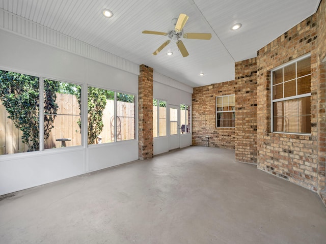 unfurnished sunroom featuring ceiling fan