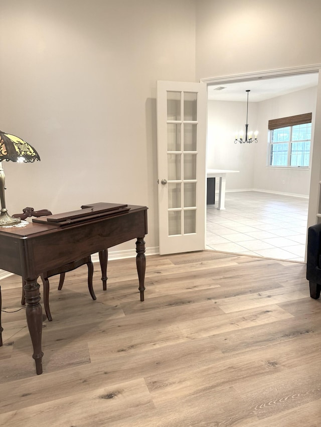 1767 Bridgeport Colony Ln, Fort Walton Beach, FL 32547 - sitting room with a chandelier, french doors, and light wood-type flooring