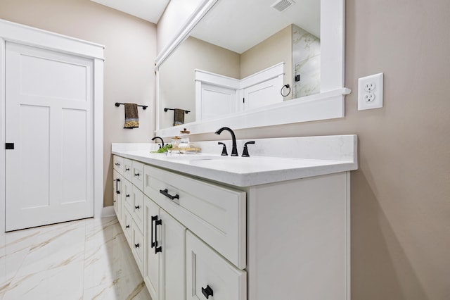full bathroom featuring double vanity, visible vents, marble finish floor, and a sink
