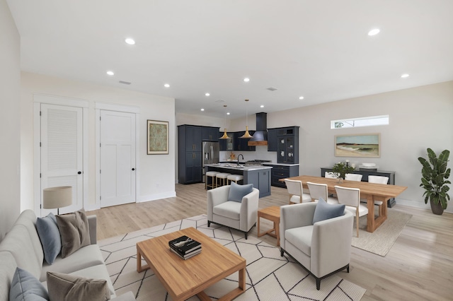 living room featuring visible vents, recessed lighting, light wood-type flooring, and baseboards