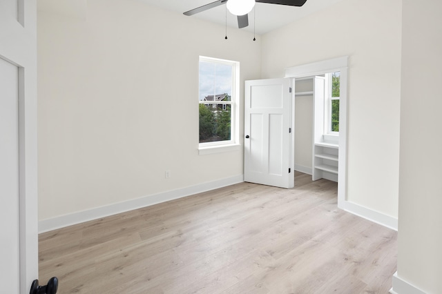 unfurnished bedroom featuring baseboards, wood finished floors, and a ceiling fan