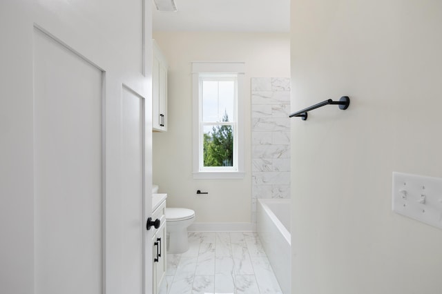 bathroom featuring marble finish floor, toilet, vanity, and baseboards