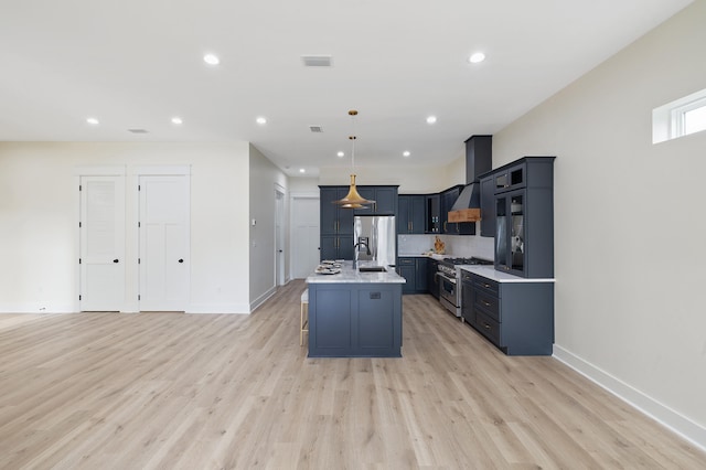 kitchen with hanging light fixtures, stainless steel appliances, light countertops, and light wood-style floors