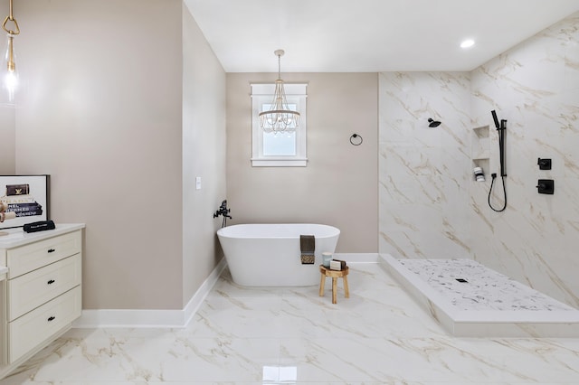 full bathroom with baseboards, a marble finish shower, a freestanding bath, marble finish floor, and a chandelier