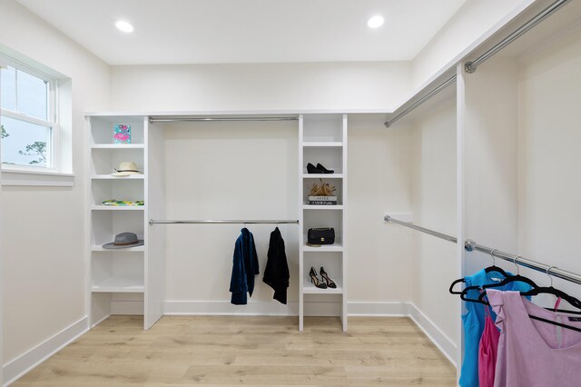 walk in closet with light wood-type flooring