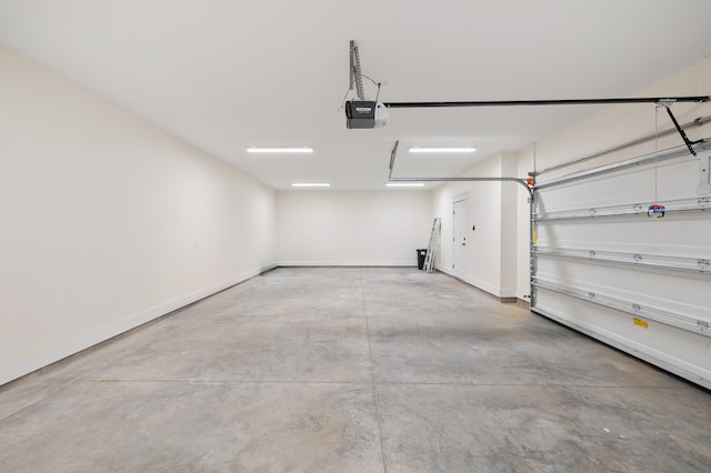 garage with baseboards and a garage door opener