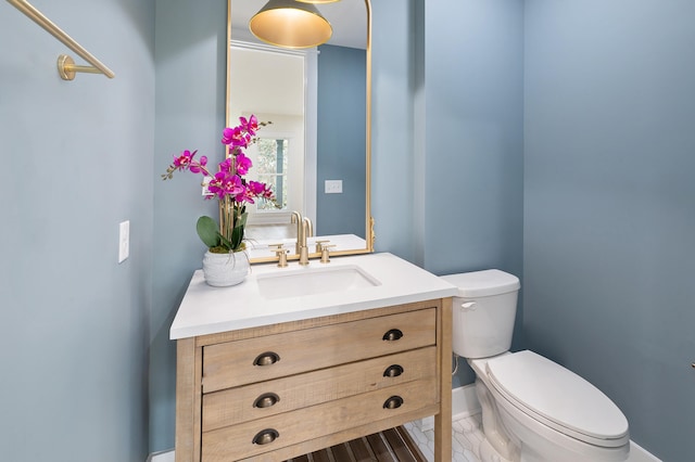 half bathroom featuring toilet and vanity