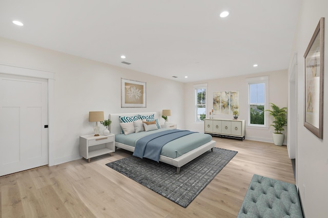 bedroom with light wood finished floors, visible vents, recessed lighting, and baseboards