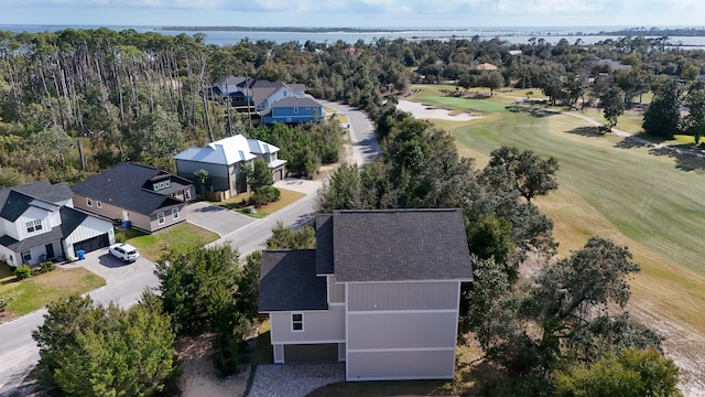 aerial view featuring golf course view, a water view, and a residential view