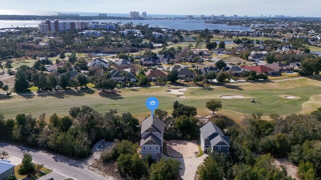 bird's eye view featuring a water view and view of golf course