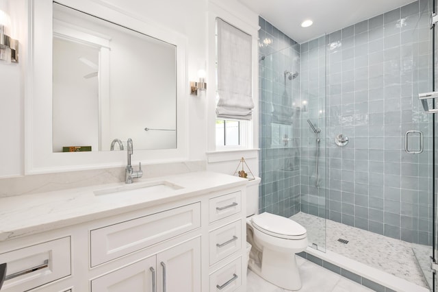 bathroom with tile patterned flooring, toilet, recessed lighting, a stall shower, and vanity