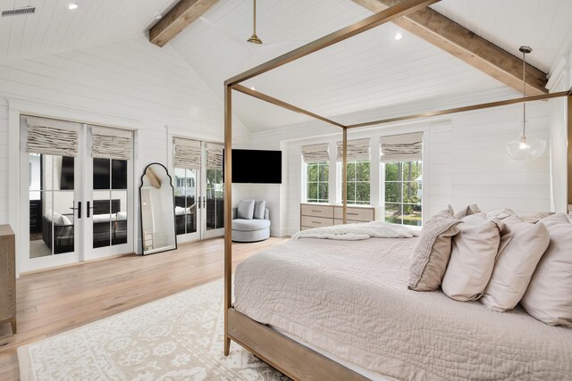 bedroom featuring light wood-type flooring, french doors, and lofted ceiling with beams