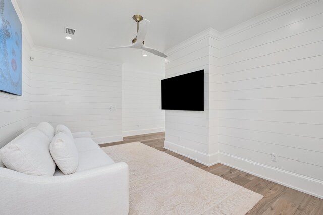 sitting room with light hardwood / wood-style flooring, ceiling fan, and ornamental molding