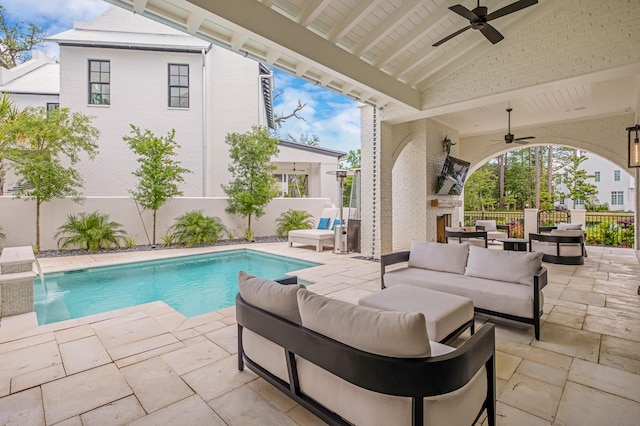 view of pool featuring ceiling fan, pool water feature, outdoor lounge area, and a patio