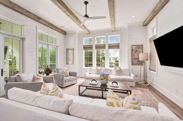 living room with hardwood / wood-style flooring, beam ceiling, and ceiling fan