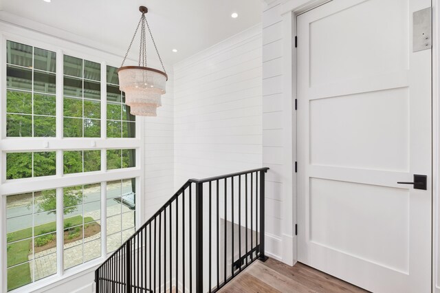 staircase featuring a notable chandelier and hardwood / wood-style floors