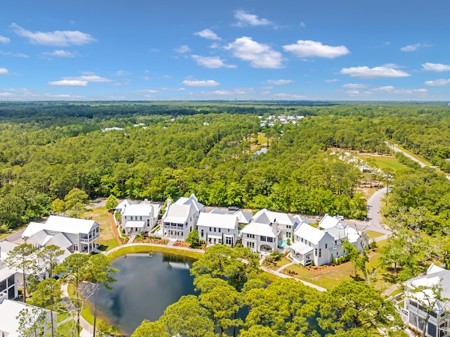 birds eye view of property with a forest view, a residential view, and a water view