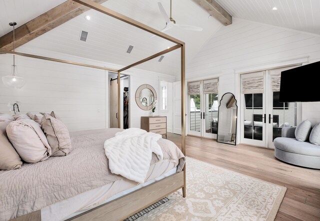 bedroom featuring vaulted ceiling with beams, light wood-type flooring, french doors, and ceiling fan