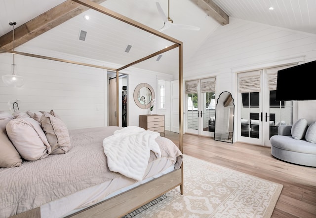 bedroom featuring access to exterior, beam ceiling, wooden walls, and wood finished floors