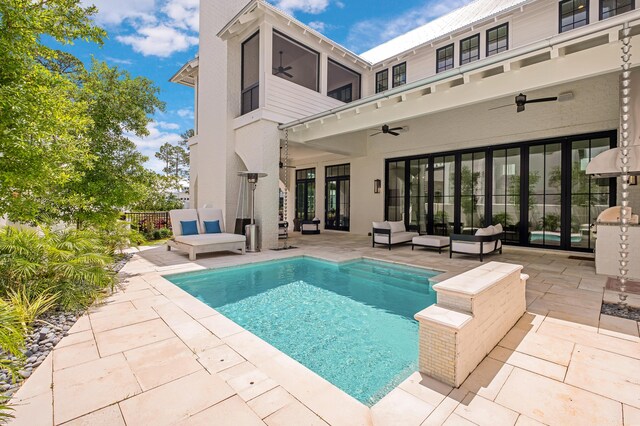 view of swimming pool featuring ceiling fan, an outdoor hangout area, and a patio area