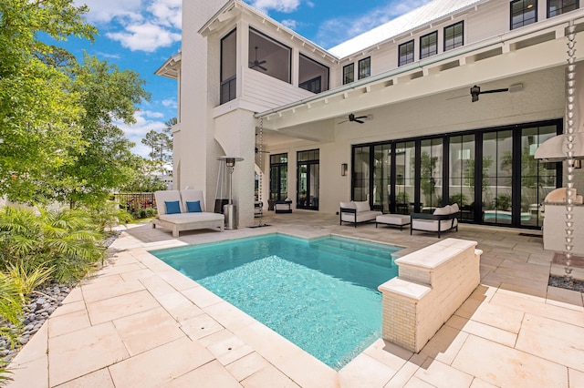 view of pool featuring a patio, a ceiling fan, a fenced in pool, and an outdoor living space