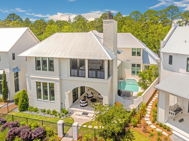 rear view of house featuring a sunroom