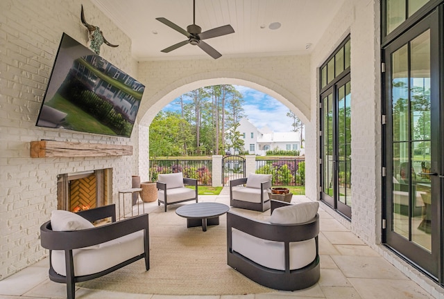 view of patio / terrace with an outdoor living space with a fireplace, a ceiling fan, and fence