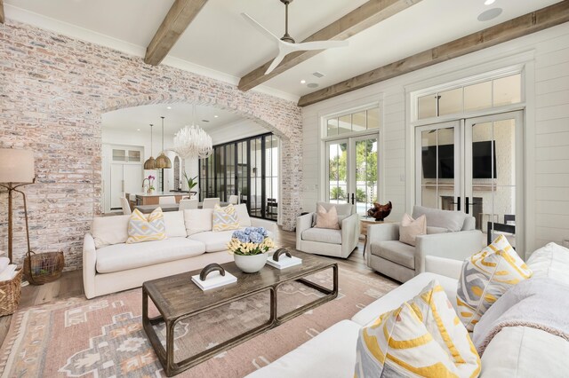 living room with ceiling fan, beam ceiling, wood-type flooring, and french doors