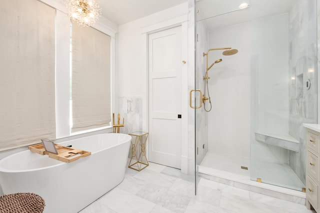 full bathroom with a freestanding tub, marble finish floor, a stall shower, and vanity