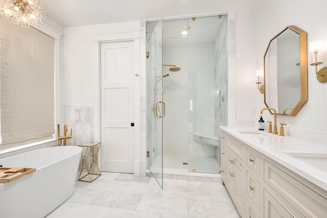 bathroom featuring a freestanding bath, double vanity, a stall shower, marble finish floor, and a sink