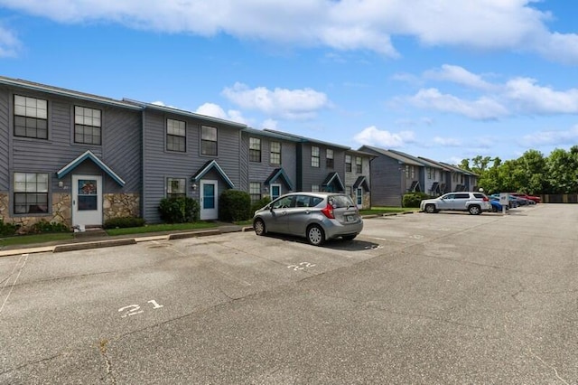 uncovered parking lot with a residential view