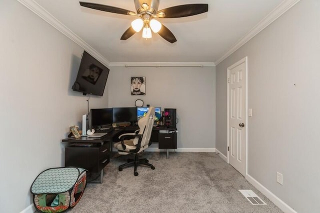 home office with ornamental molding, light colored carpet, visible vents, and baseboards