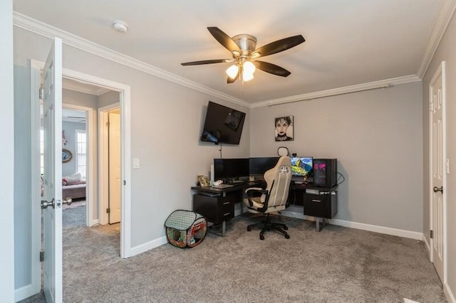 home office with a ceiling fan, light colored carpet, crown molding, and baseboards