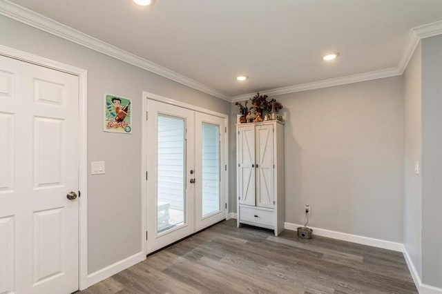 doorway featuring french doors, crown molding, baseboards, and wood finished floors