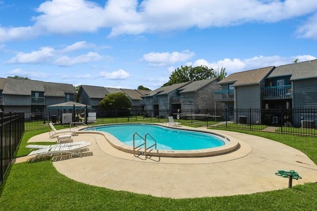 community pool with a residential view, a lawn, a patio, and fence