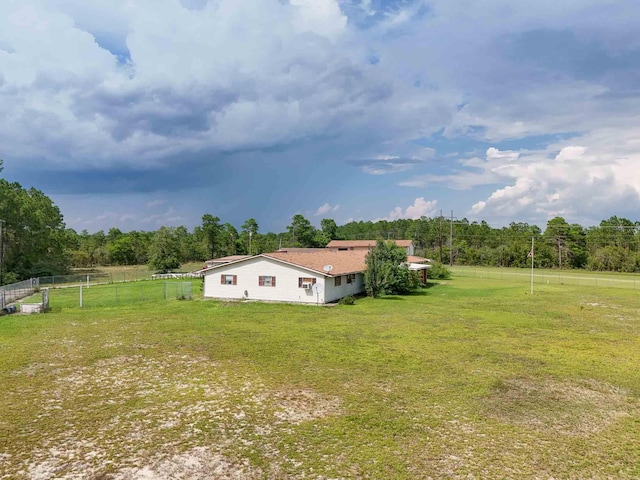 exterior space with a rural view and a lawn