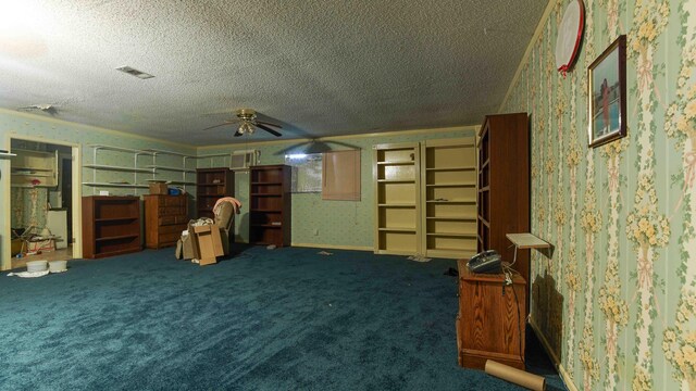 interior space featuring carpet flooring, a textured ceiling, and ceiling fan