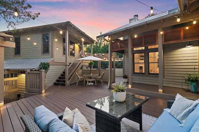 deck at dusk with outdoor lounge area