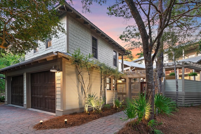 property exterior at dusk with a garage