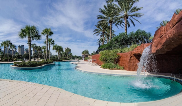 view of swimming pool with pool water feature