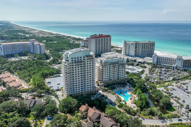 birds eye view of property featuring a beach view and a water view