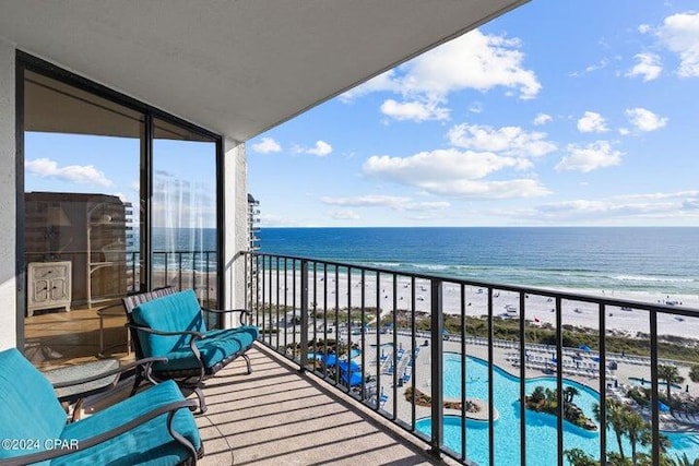 balcony featuring a beach view and a water view