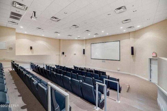 home theater room featuring light colored carpet and a drop ceiling