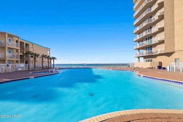 view of pool with a water view