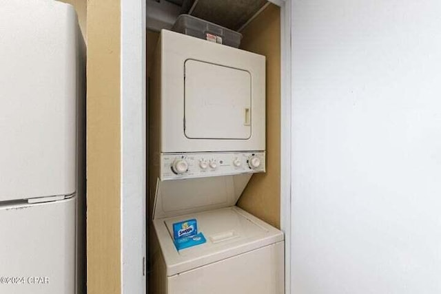 laundry room with stacked washer / drying machine