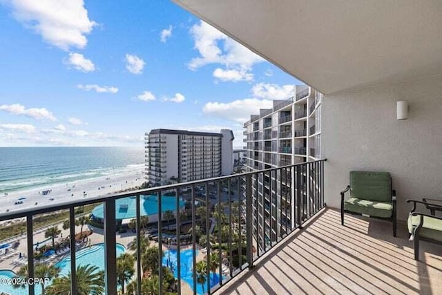 balcony with a beach view and a water view