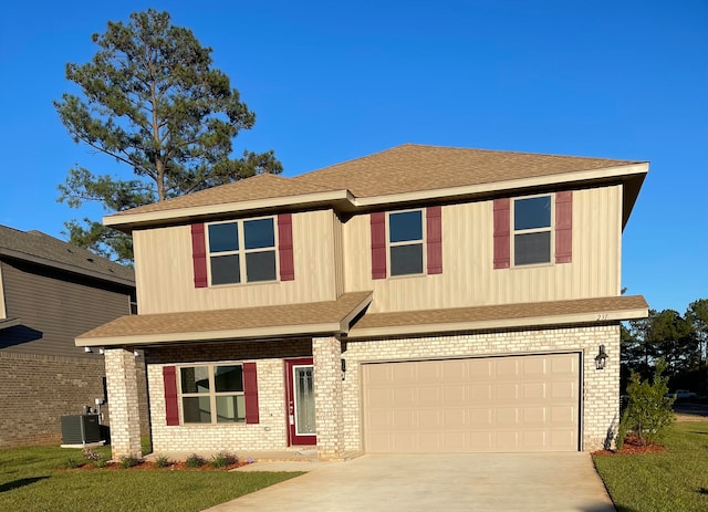 view of front of house with a garage and central AC