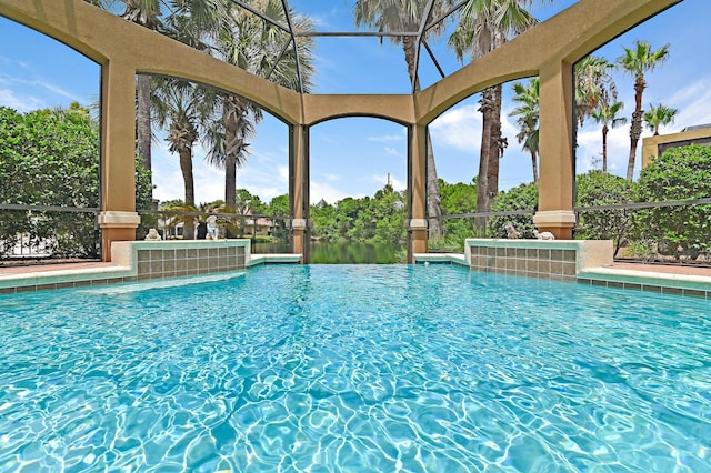 view of swimming pool with a lanai