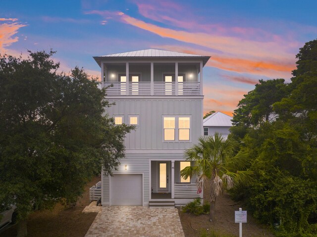 view of front of home with a garage and a balcony